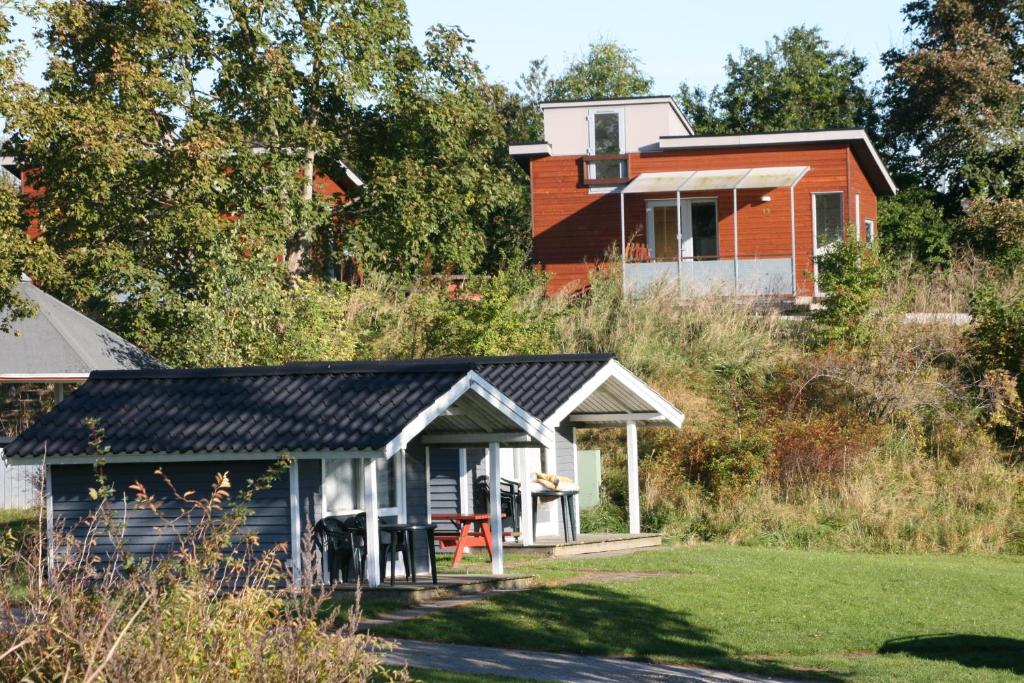 a house on top of a hill with a yard at Sorø Camping & Cottages in Sorø