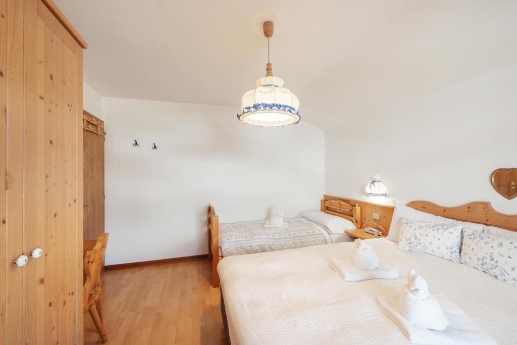 Postel nebo postele na pokoji v ubytování Albergo Vezzana