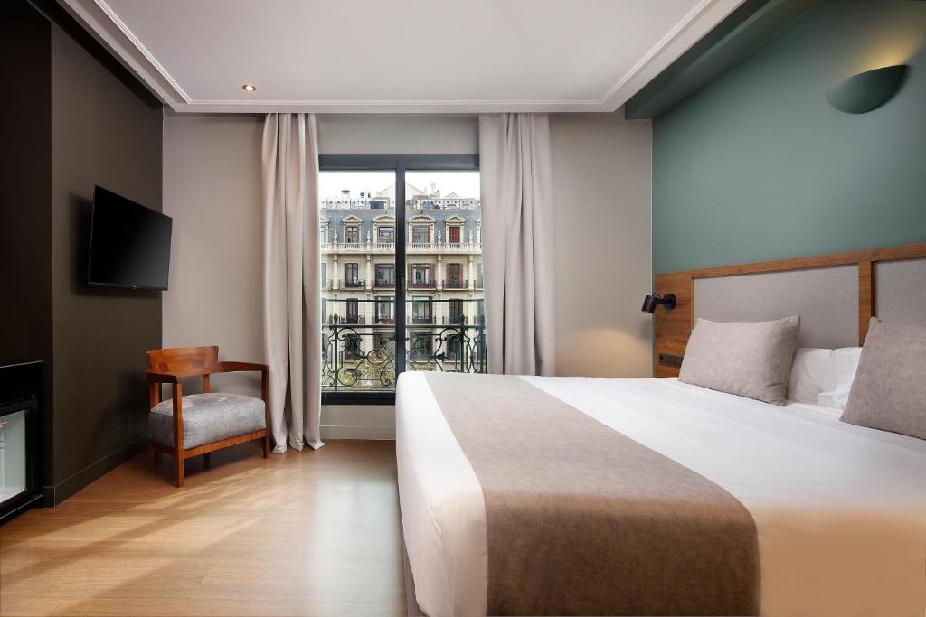 Llit o llits en una habitació de Wilson Boutique Hotel