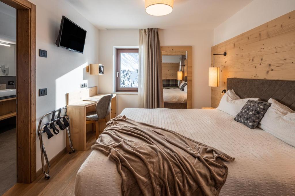 Postel nebo postele na pokoji v ubytování Albergo Vezzana