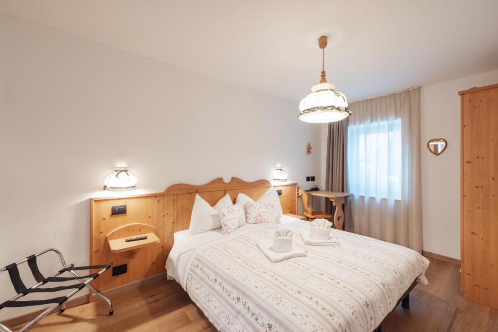Postel nebo postele na pokoji v ubytování Albergo Vezzana