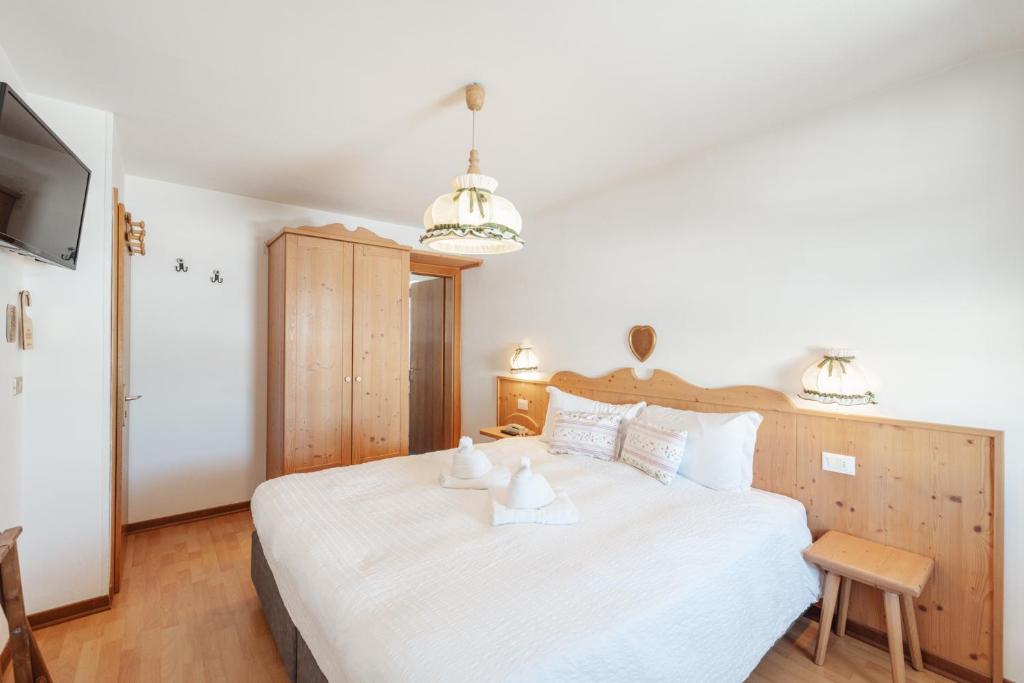 Postel nebo postele na pokoji v ubytování Albergo Vezzana