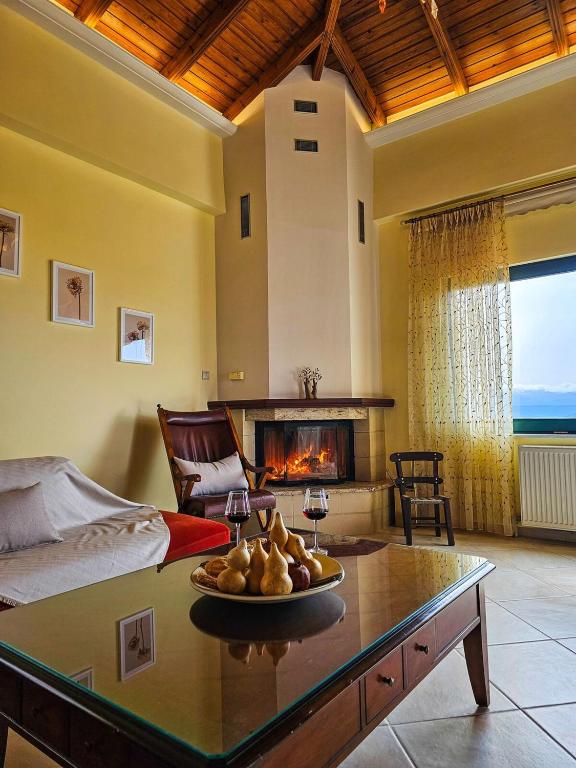 a living room with a bed and a fireplace at Villa Aitheras with sea views and garden in Stérnai