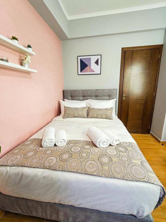 a bedroom with a large bed with two pillows at Villa Aitheras with sea views and garden in Stérnai