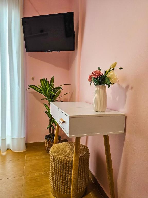 a room with a table with a tv on a wall at Villa Aitheras with sea views and garden in Stérnai