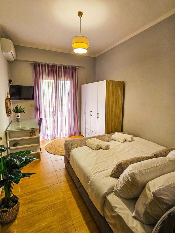 a bedroom with a large bed and a window at Villa Aitheras with sea views and garden in Stérnai