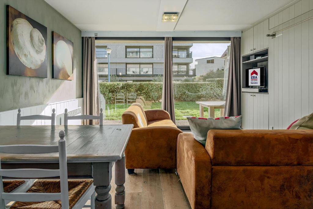 a living room with a couch and a table at Rietpanne Gv06 in Sint-Idesbald