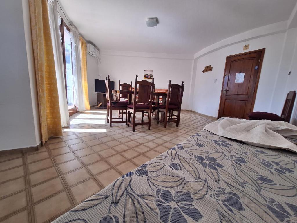 a bedroom with a table and chairs and a dining room at Apartment Chunin Depart in Salta