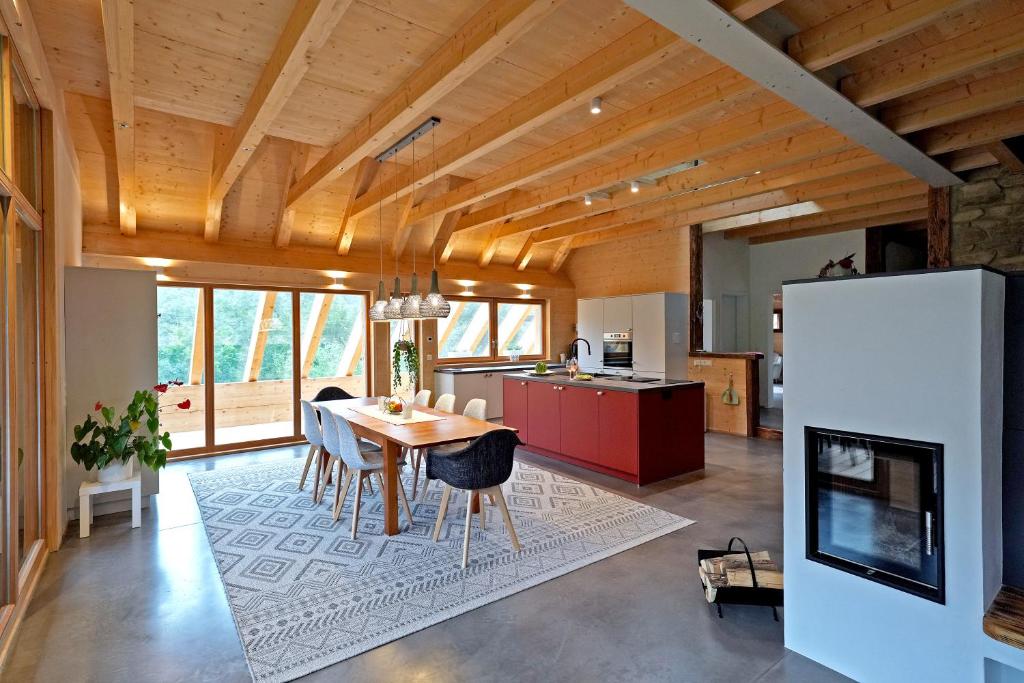 a kitchen and dining room with a table and chairs at Haldenhof, Design Retreat im Schwarzwald by living TIMELESS in Simonswald