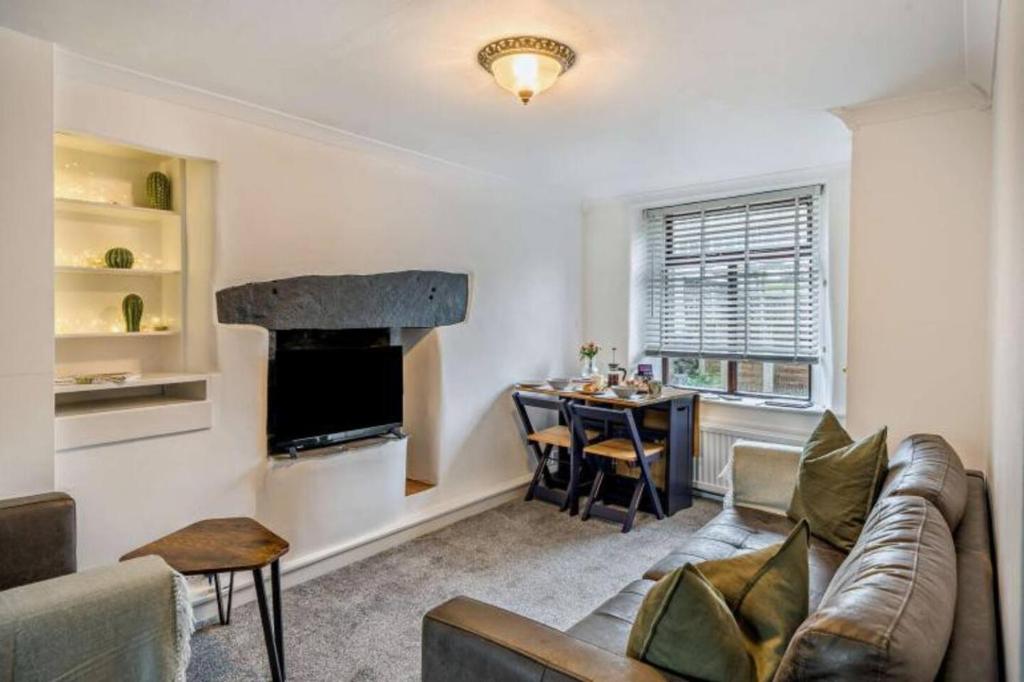 a living room with a couch and a table at Quarter Deck in Ulverston