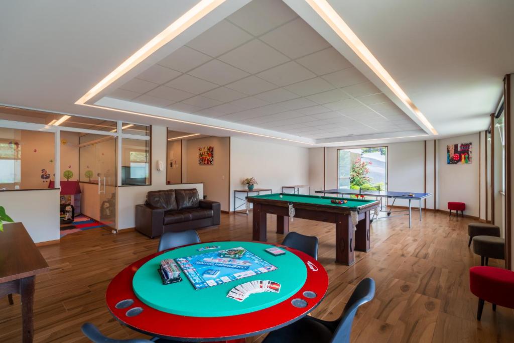 a room with a ping pong table and ping pong balls at Pousada Grandchamp - Campos do Jordao in Campos do Jordão