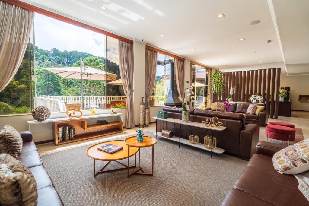 a living room with a couch and a table at Pousada Grandchamp - Campos do Jordao in Campos do Jordão
