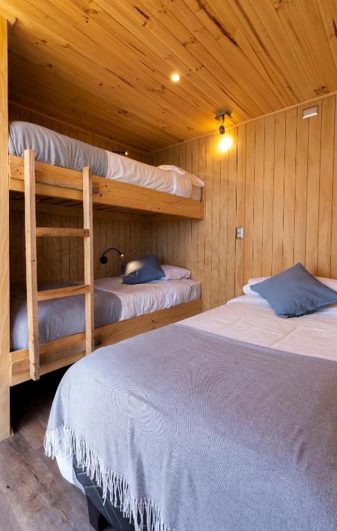 Postel nebo postele na pokoji v ubytování OUTSCAPE l Cabañas Lago Puyehue