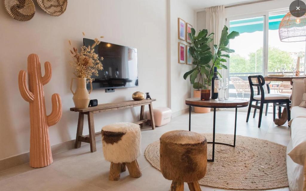 a living room with cacti and a table and chairs at La Casita Bonita - 30m from the Arenal Beach - Private Parking in Jávea