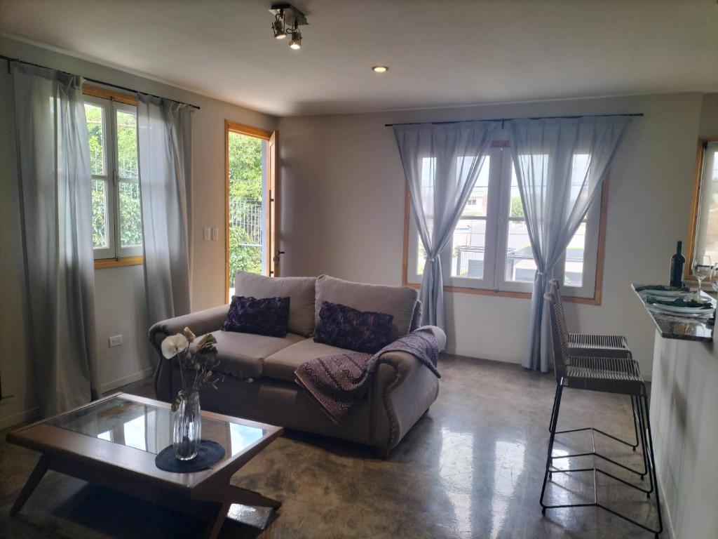 a living room with a couch and a table at Relax MDZ - Memorable Apt in Godoy Cruz