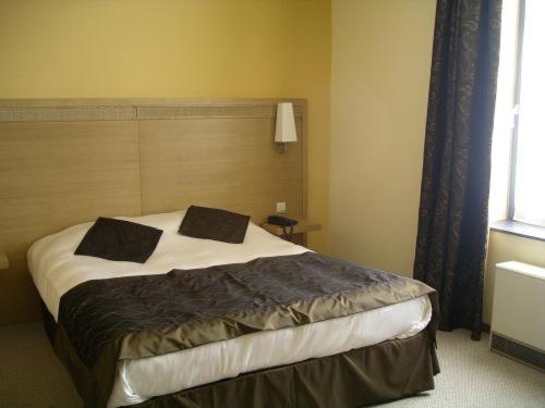 Postel nebo postele na pokoji v ubytování Hotel Les Mignees