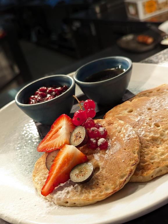 a plate of food with pancakes and fruit on it at Harbour Heights Hotel in Poole