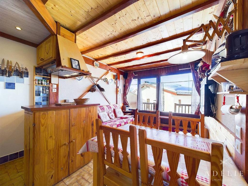 une cuisine et une salle à manger avec une table et des chaises dans l'établissement Studio cabine pour 4 pers. au pied des pistes avec terrasse et parking, Montvalezan - FR-1-398-648, à Montvalezan