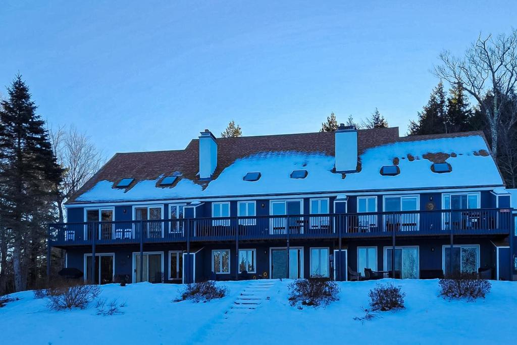 a large blue building with snow on the ground at Mountain Memories in Bartlett