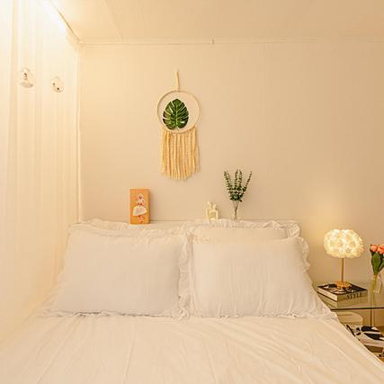 a white bed with white pillows in a bedroom at Noddle Sun Stay in Seoul