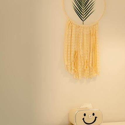 a wall with a clock and a dream catcher at Noddle Sun Stay in Seoul