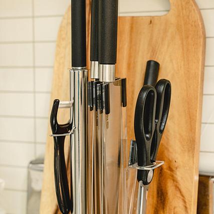 a group of kitchen utensils on a wooden cutting board at Noddle Sun Stay in Seoul