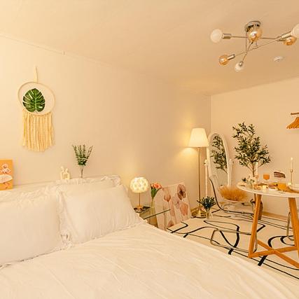 a white bedroom with a bed and a table at Noddle Sun Stay in Seoul