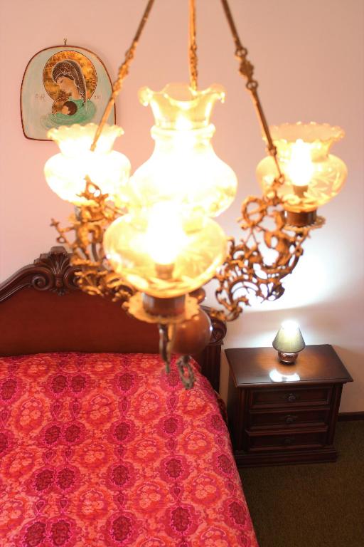 a chandelier hanging over a bed in a bedroom at Discover Italy in Tignes