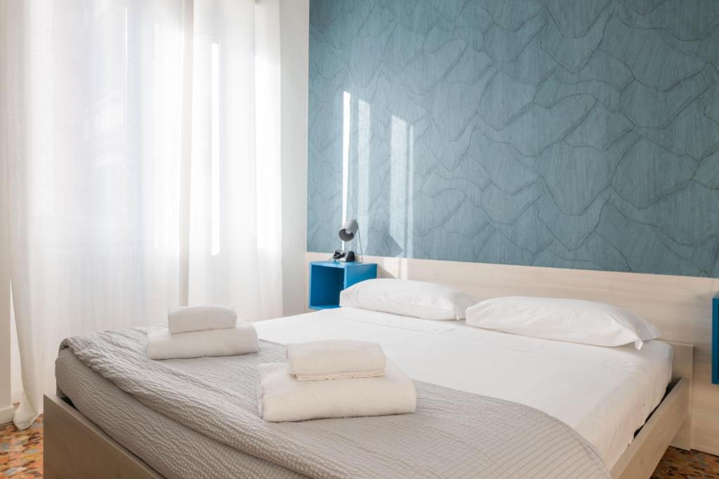 a bedroom with a bed with two towels on it at BG Stay in Bergamo