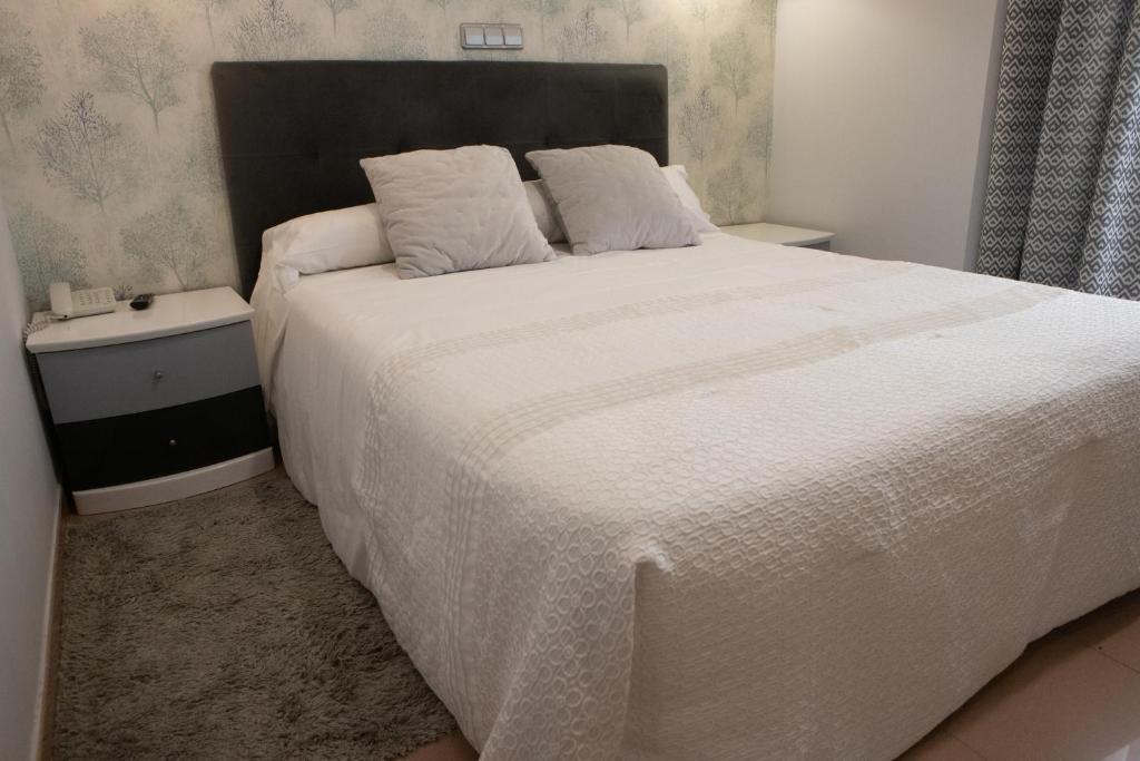Postel nebo postele na pokoji v ubytování Hotel Las Moradas