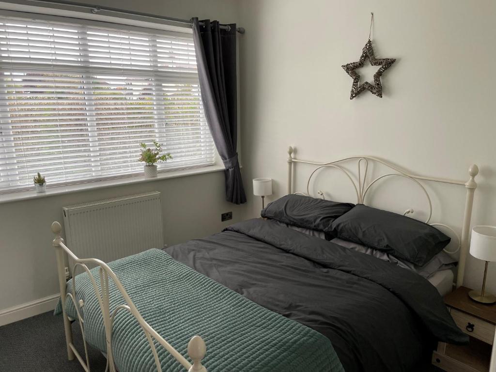 a bedroom with a bed with a star on the wall at Nidd House Apartment in Harrogate