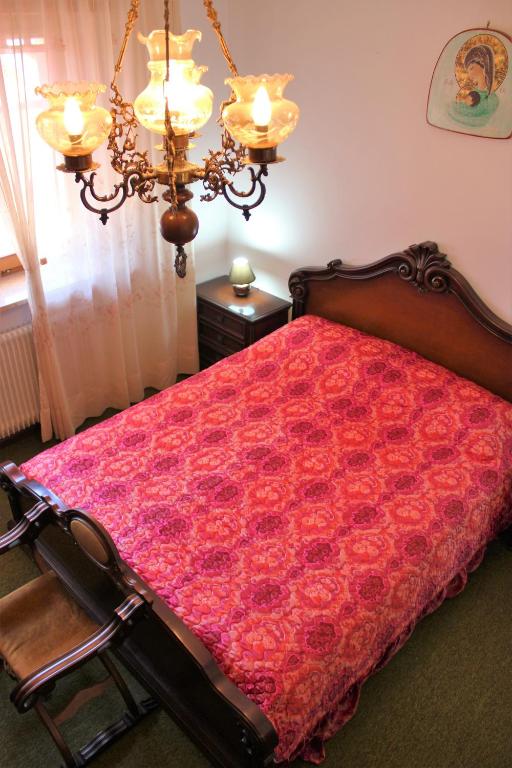 a bedroom with a bed with a red comforter at Discover Italy in Tignes