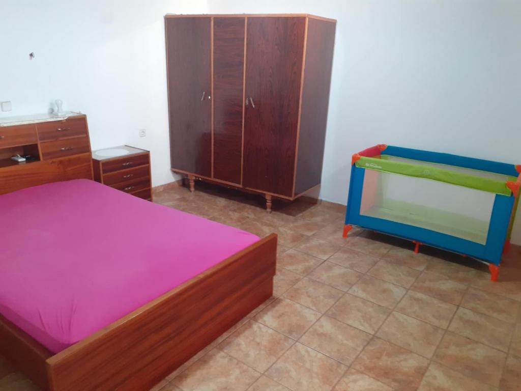 a bedroom with two beds and a dresser at house FYNTIKAKH - SKALA in Anopoli Sfakion