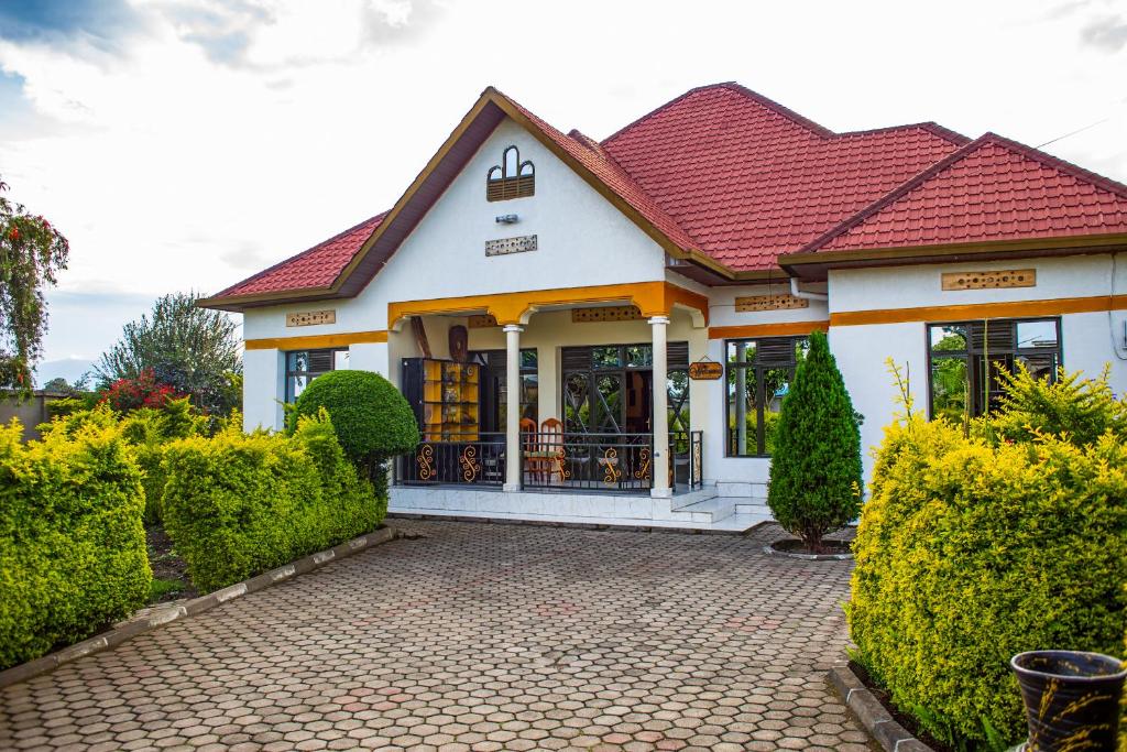 a small white house with a red roof at Virunga House in Ruhengeri