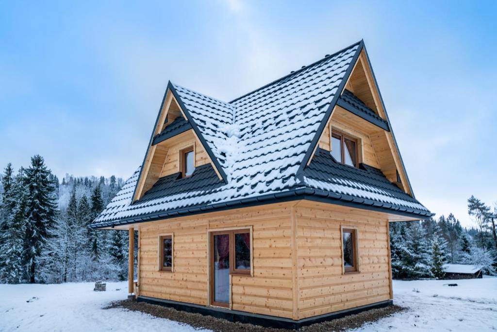 a house with a metal roof on top of it at Góralski domek nad Białką in Jurgów