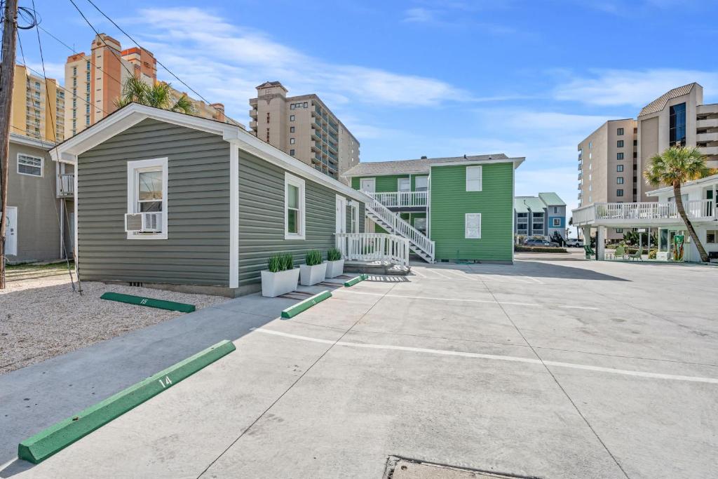 ein kleines Haus in einer Stadt mit Gebäuden in der Unterkunft Cozy Beachside Bungalow Studio Ideal for Couples in Myrtle Beach