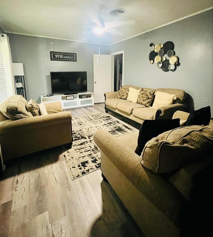 Una sala de estar con dos sofás y un televisor de pantalla plana. en Center City Family Getaway, en Columbus