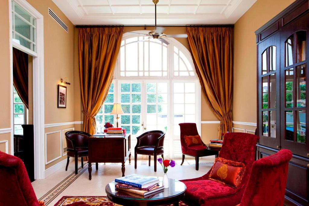 A bright heritage-style sitting room opens onto a large arched window.