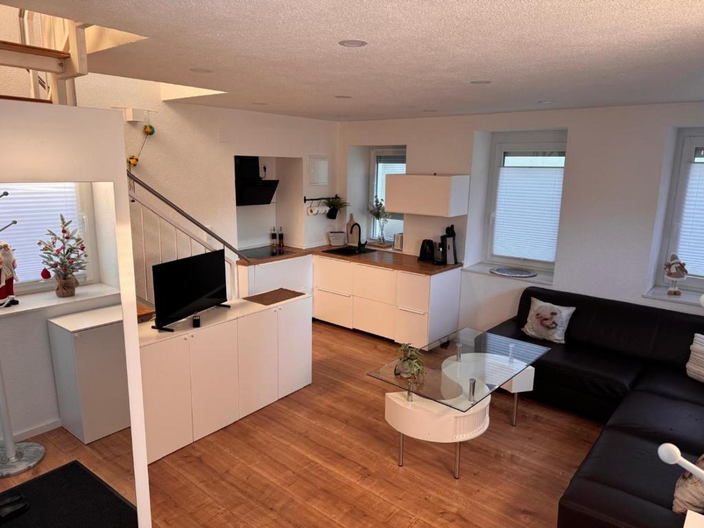a living room with a couch and a table at Traumhaft moderne Ferienhaus-Tiny House in 78554 Aldingen in Aldingen