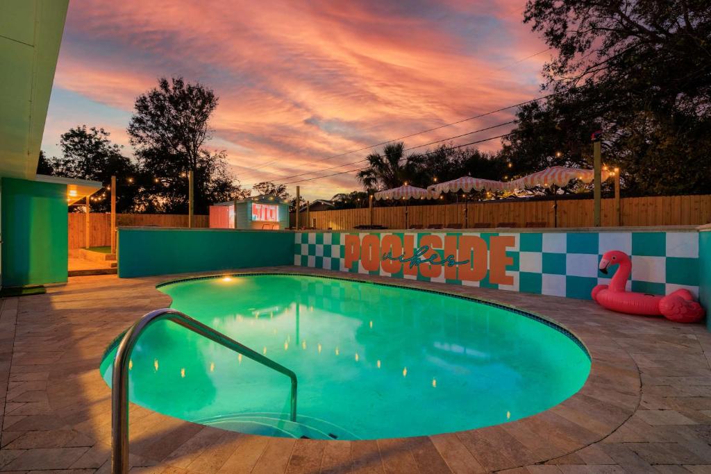 a swimming pool at night with a flamingo in the background at Private Pool 6 MI to Clearwater Beach Fire Pit Game Room in Clearwater