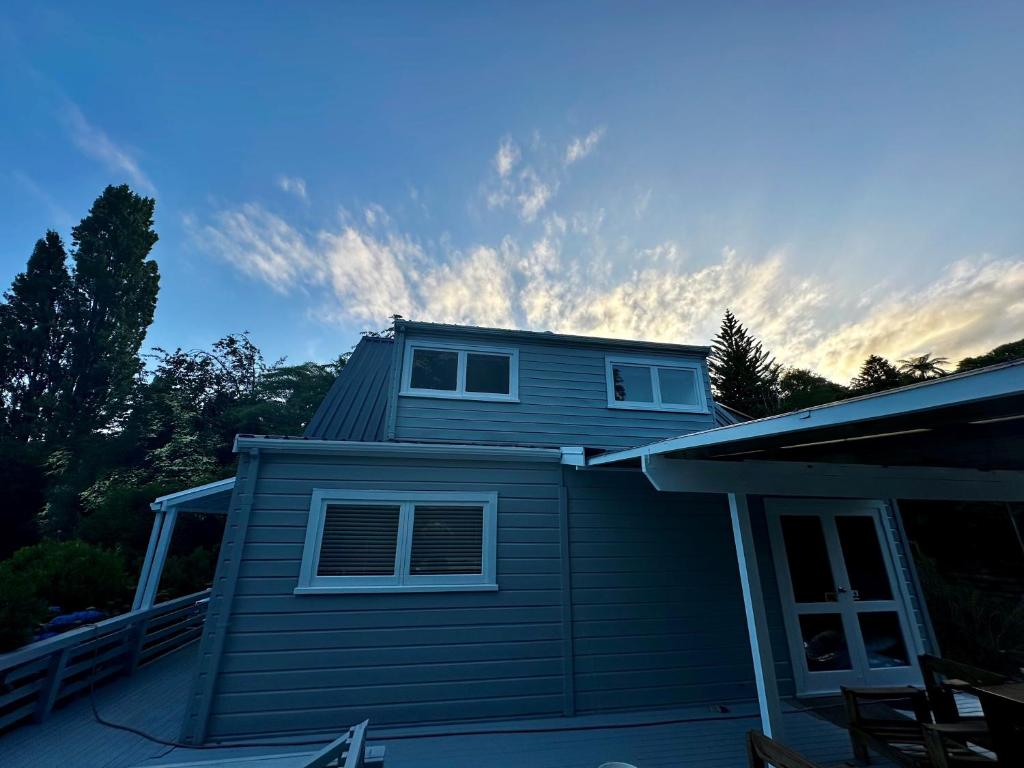 a house with a roof on top of it at Lake Okareka Calder Road Cottage in Rotorua
