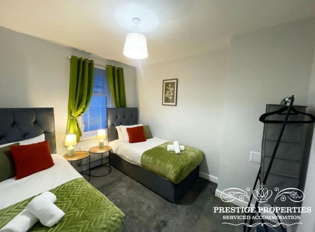 a hotel room with two beds and a window at Jackson St by Prestige Properties SA in Siddick