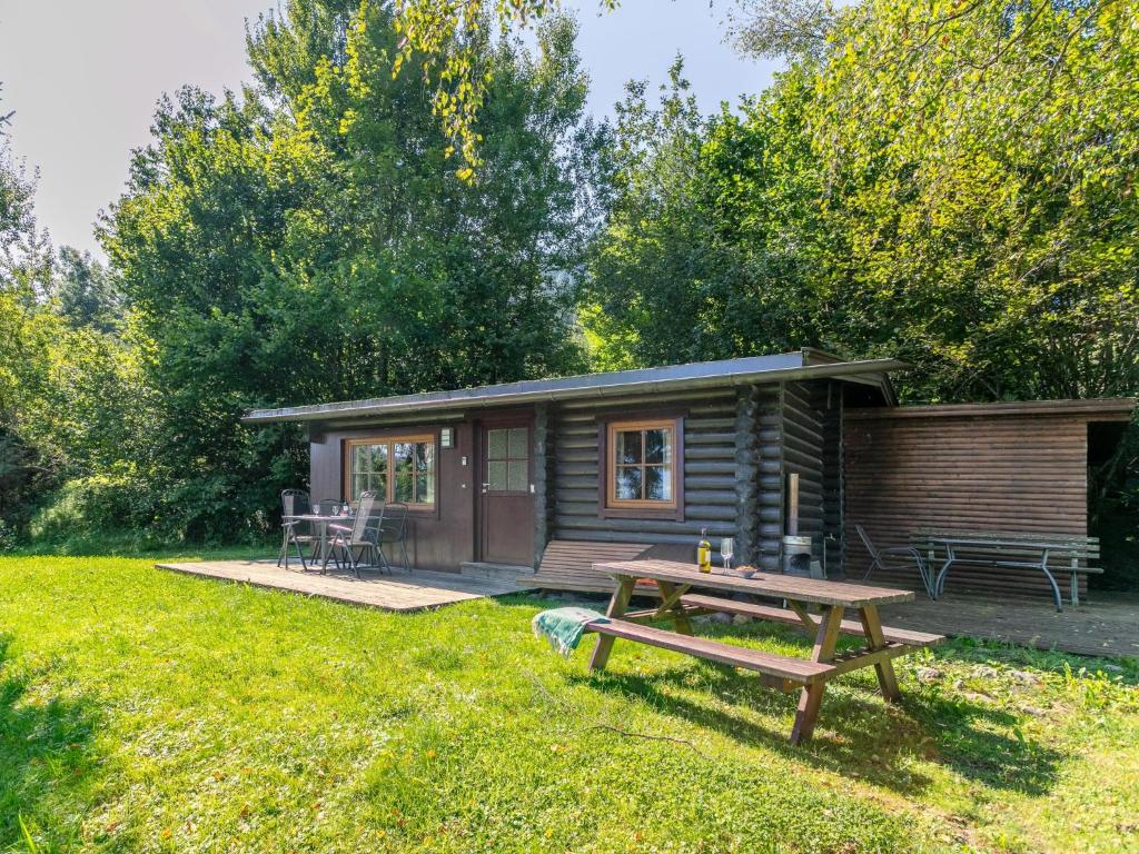 a log cabin with a picnic table in the yard at Im Brixenthal I in Wörgl