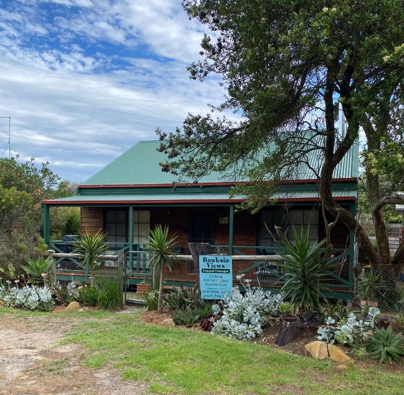 a house with a sign in front of it at Banksia Views in Sandy Point