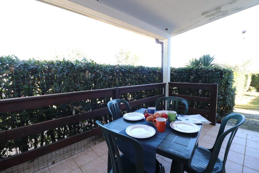 stół z krzesłami i talerzami jedzenia na balkonie w obiekcie Casa Regina Residence Torre Santo Stefano in Otranto 3 places w mieście Alimini