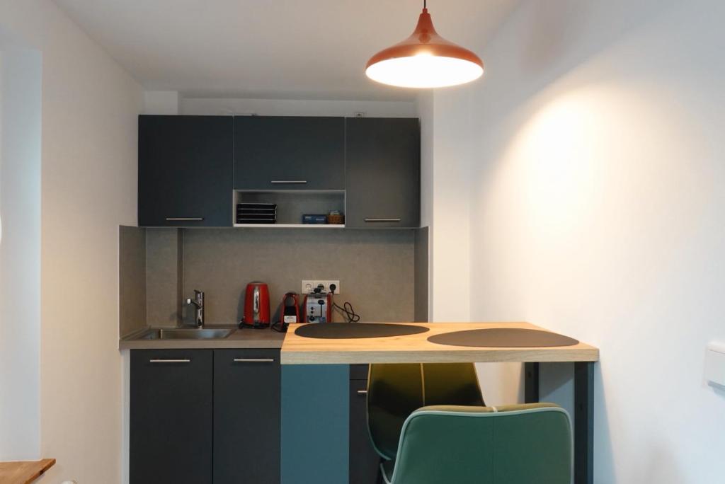 a kitchen with a table and chairs in a room at 501 Comfort Housing in Falkensee