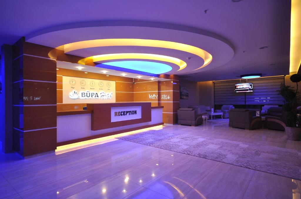a lobby with a waiting area with a sign on the wall at Bupa Hotel in Kayseri