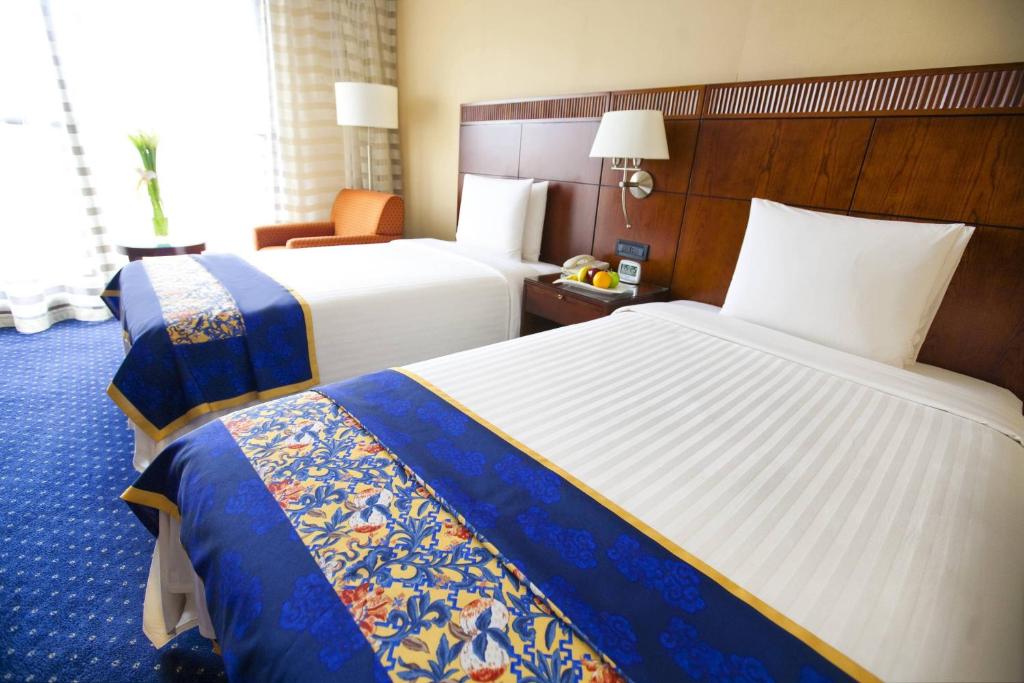 Postel nebo postele na pokoji v ubytování Courtyard By Marriott Shanghai Pudong