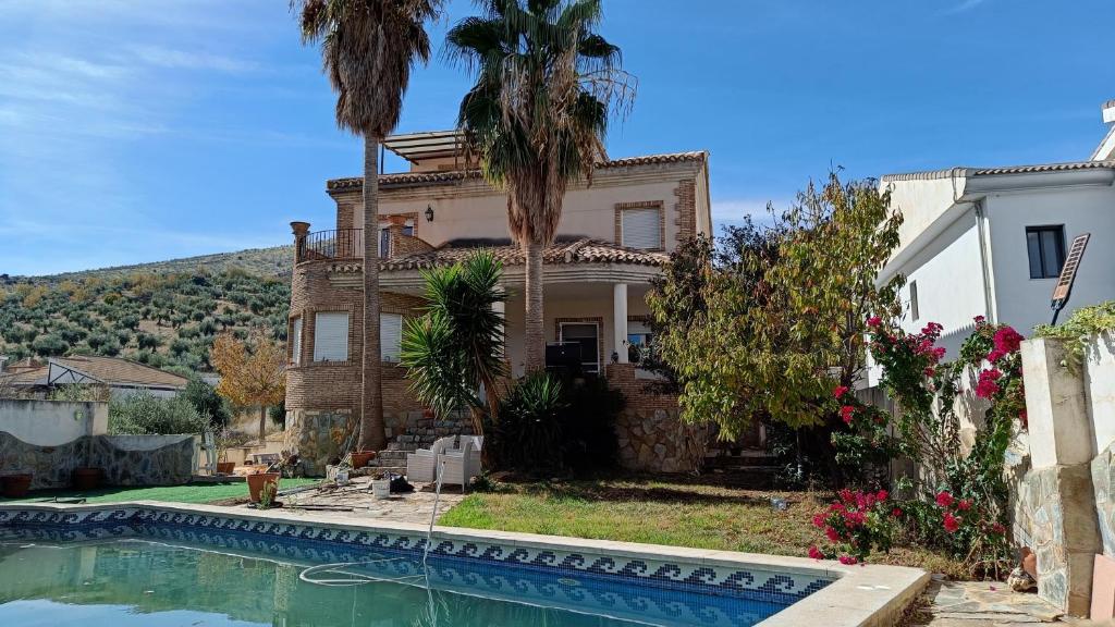a house with a swimming pool in front of it at Vivienda Rural Paraje El Sotillo in Carchel