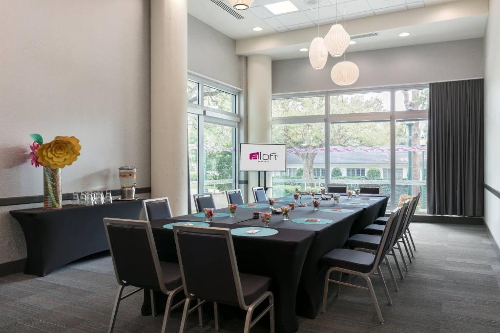 a conference room with a long table and chairs at Aloft Sarasota in Sarasota